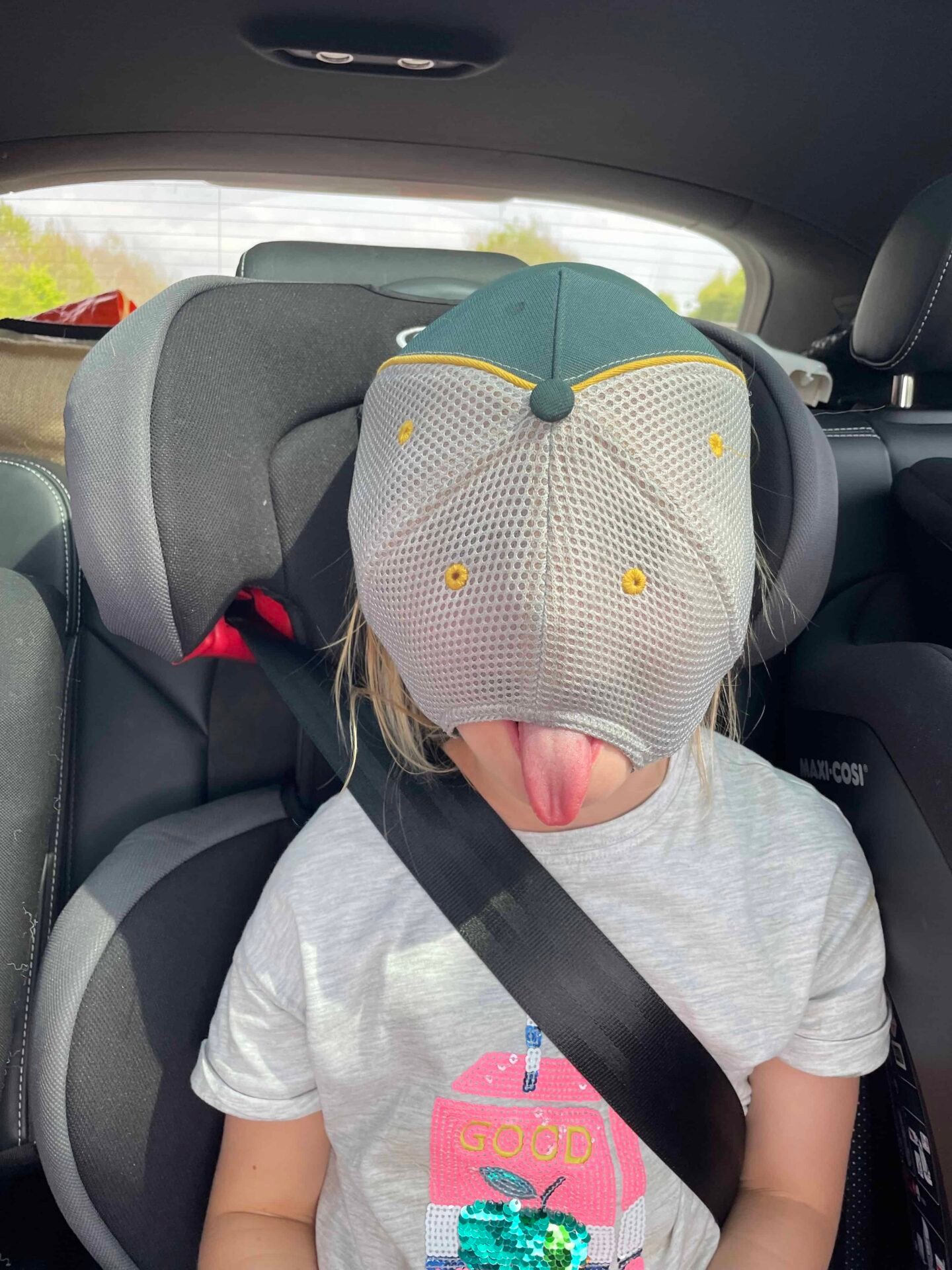 kid in a hat in car