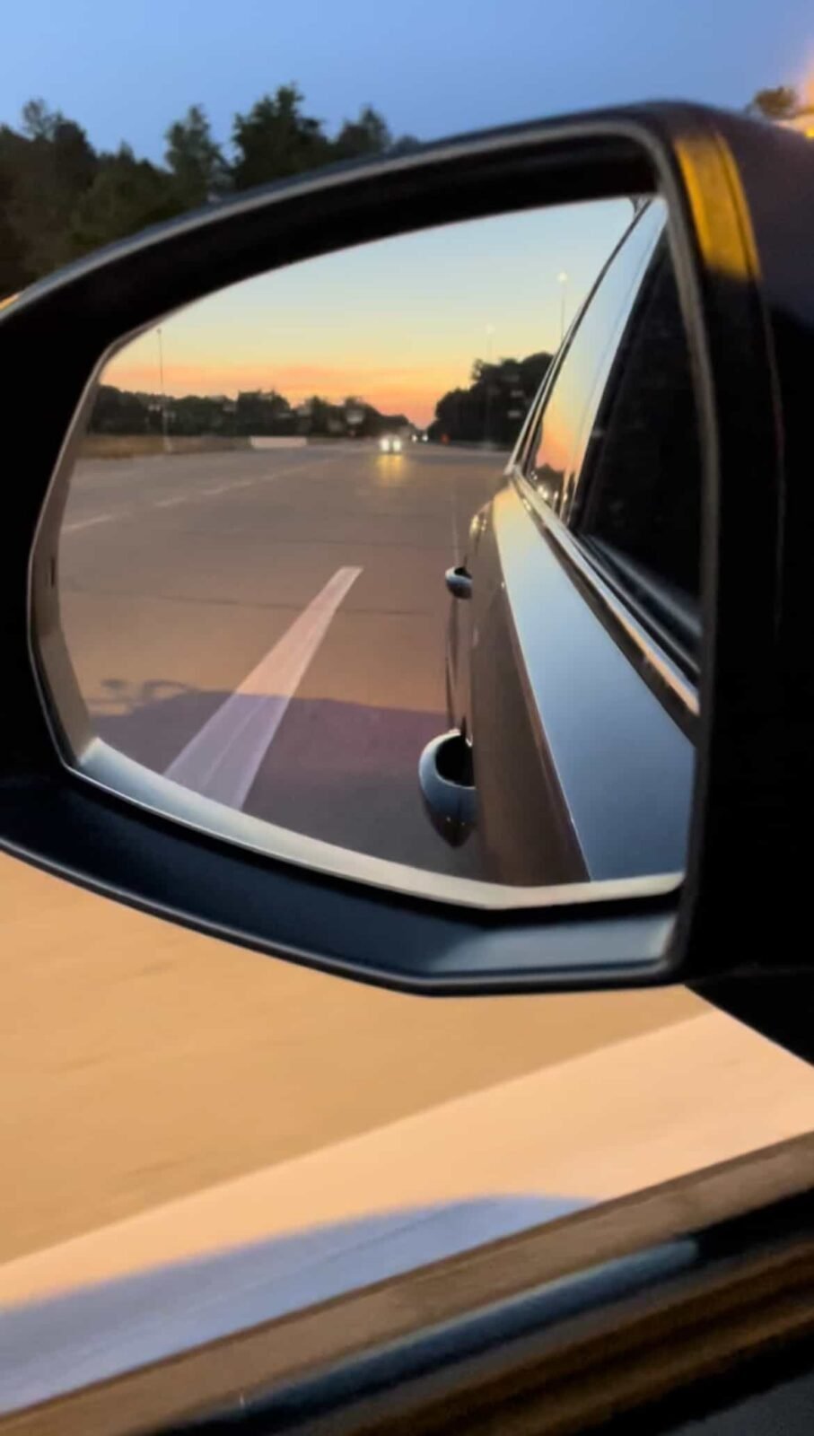 sun set in the wing mirror