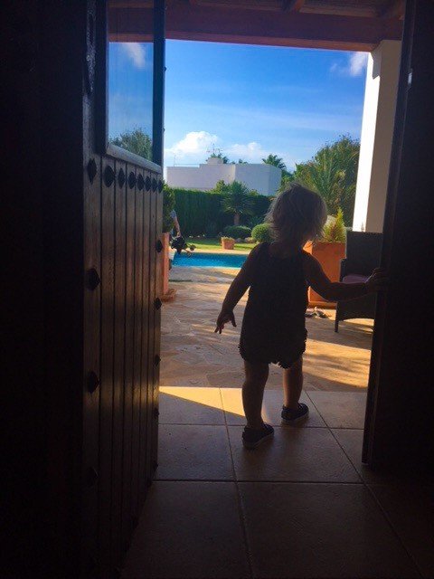 toddler walking out villa door