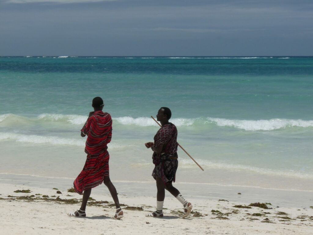 Masaii walking on beach in Zanzibar, Tanzania