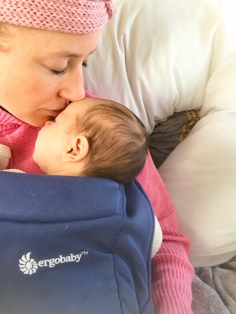 Ergobaby embrace baby carrier head kiss
