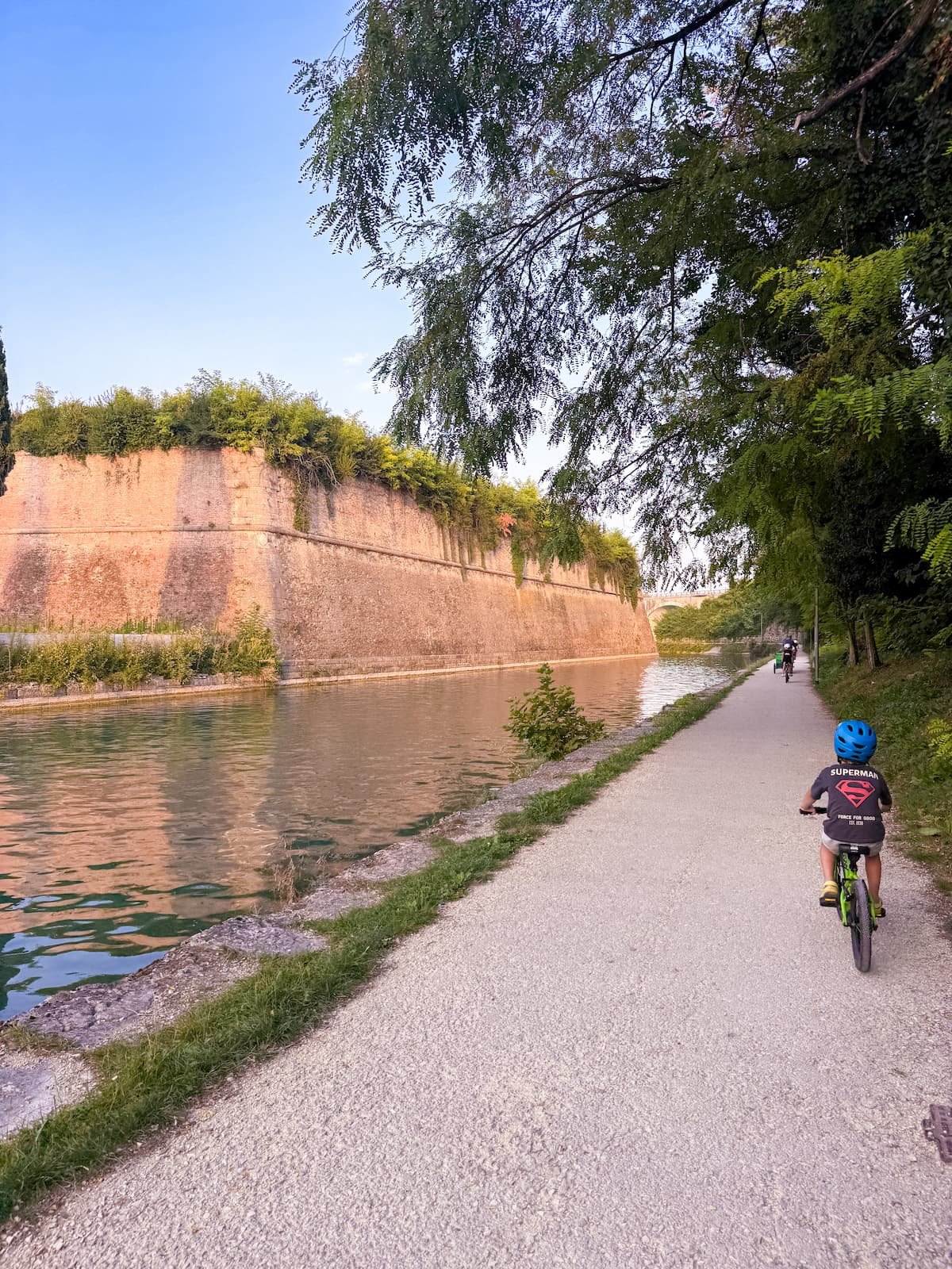 Family cycling the Mantua-Peschiera cycle path from Hu Altomincio Village